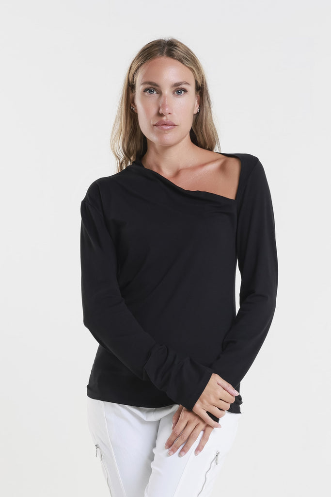 Woman wearing a black long-sleeve top with a white background