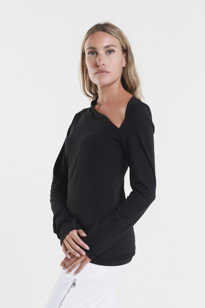 Woman wearing a black long-sleeve top on a white background