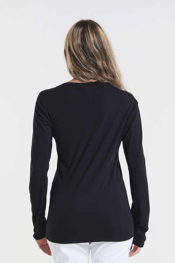 Person wearing a black long-sleeve top on a white background