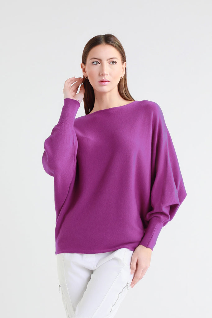 Woman wearing a purple sweater on a white background