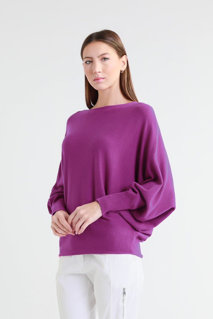 Woman wearing a purple sweater on a white background