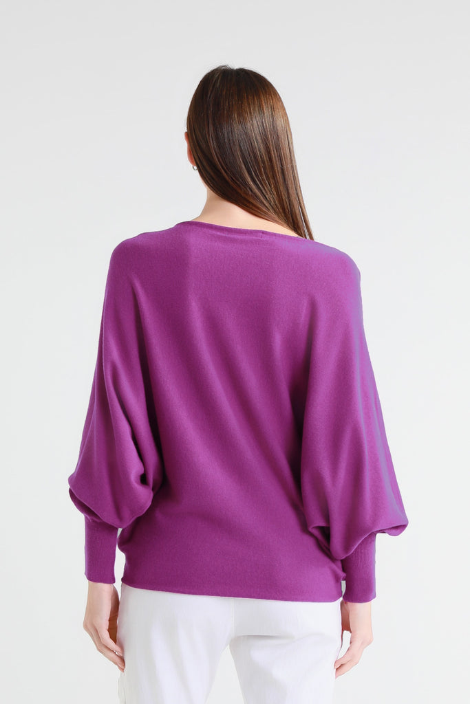 Woman wearing a purple sweater on a white background