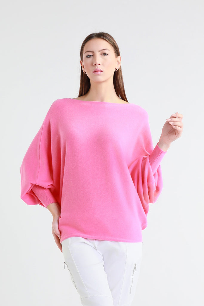 Woman wearing a bright pink sweater on a white background