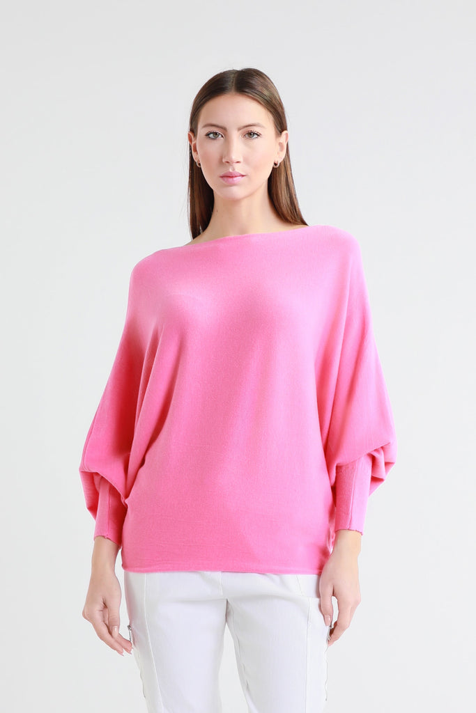 Woman wearing a bright pink top on a white background