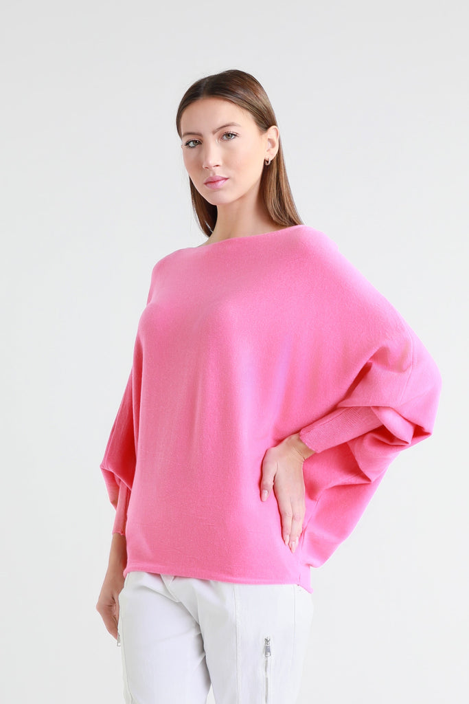 Woman wearing a pink sweater on a white background
