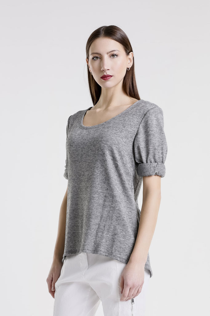 Woman wearing a gray short-sleeve top against a white background