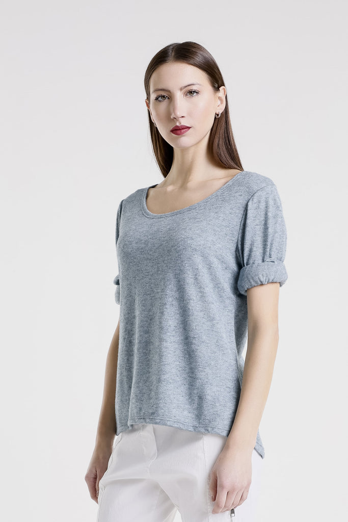 Woman wearing a light blue sweater on a white background