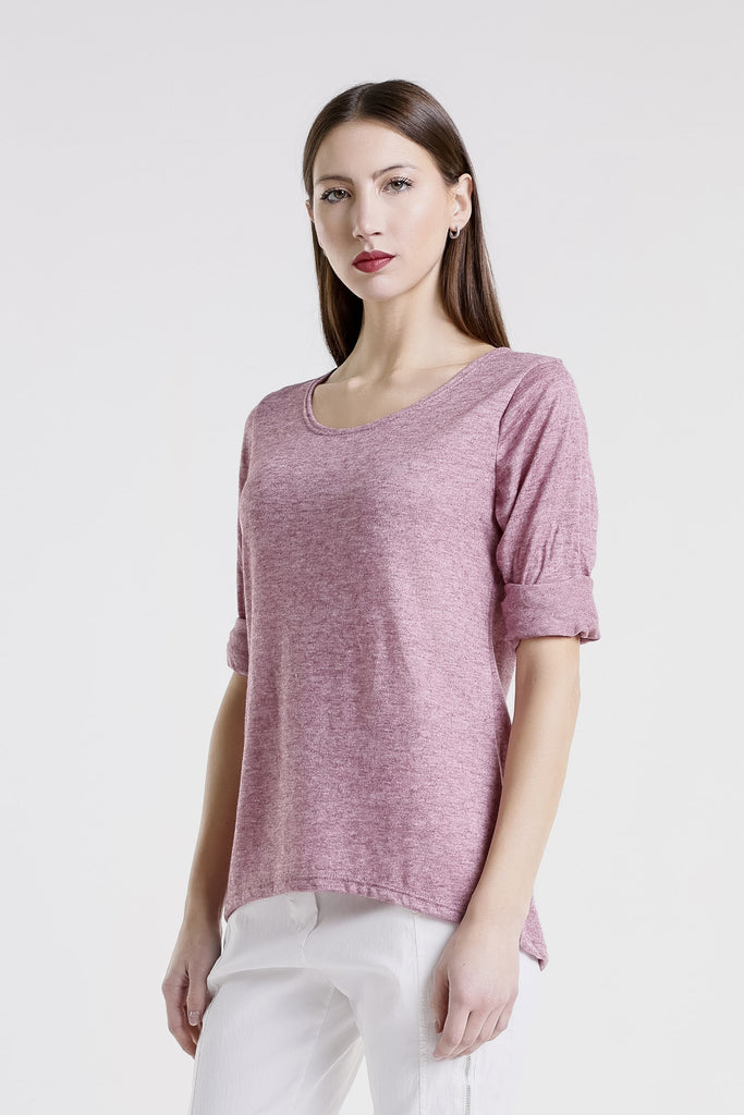 Woman wearing a pink sweater on a white background