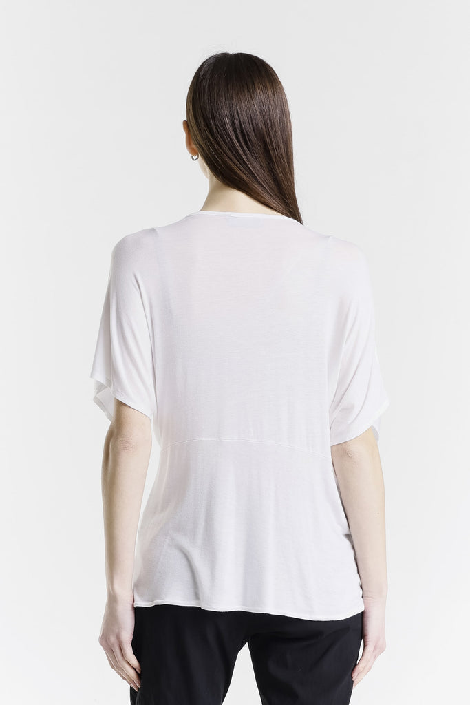 Woman wearing a white t-shirt on a plain background