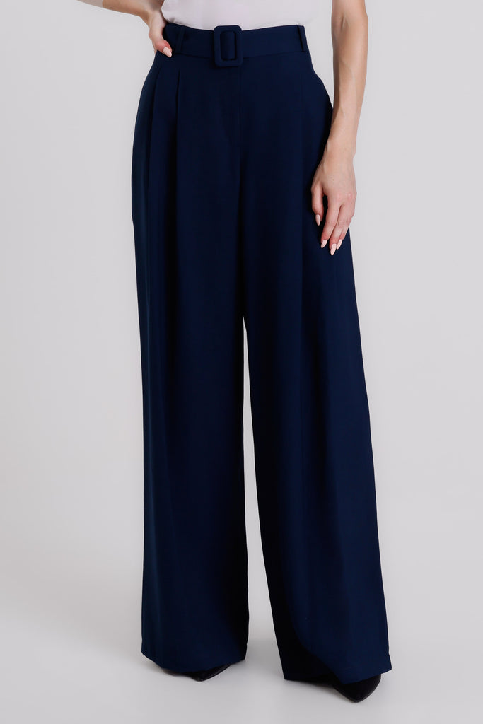 Navy blue wide-leg pants worn by a person on a light gray background