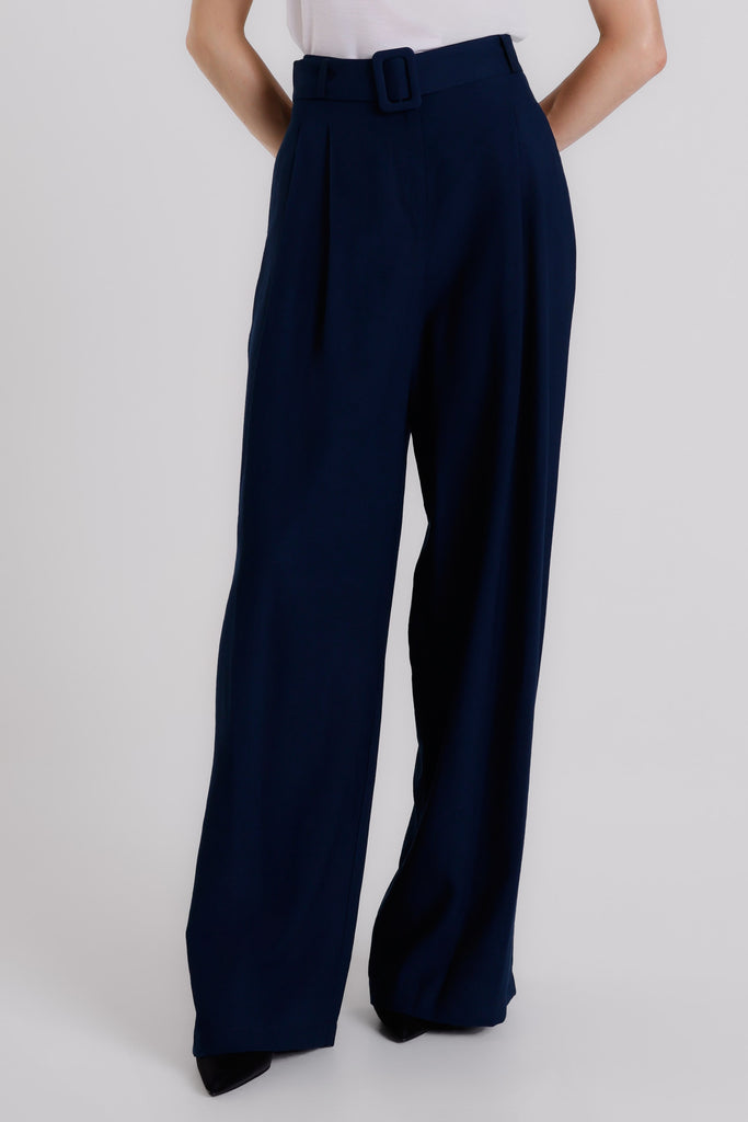 Navy blue wide-leg pants worn by a person on a white background