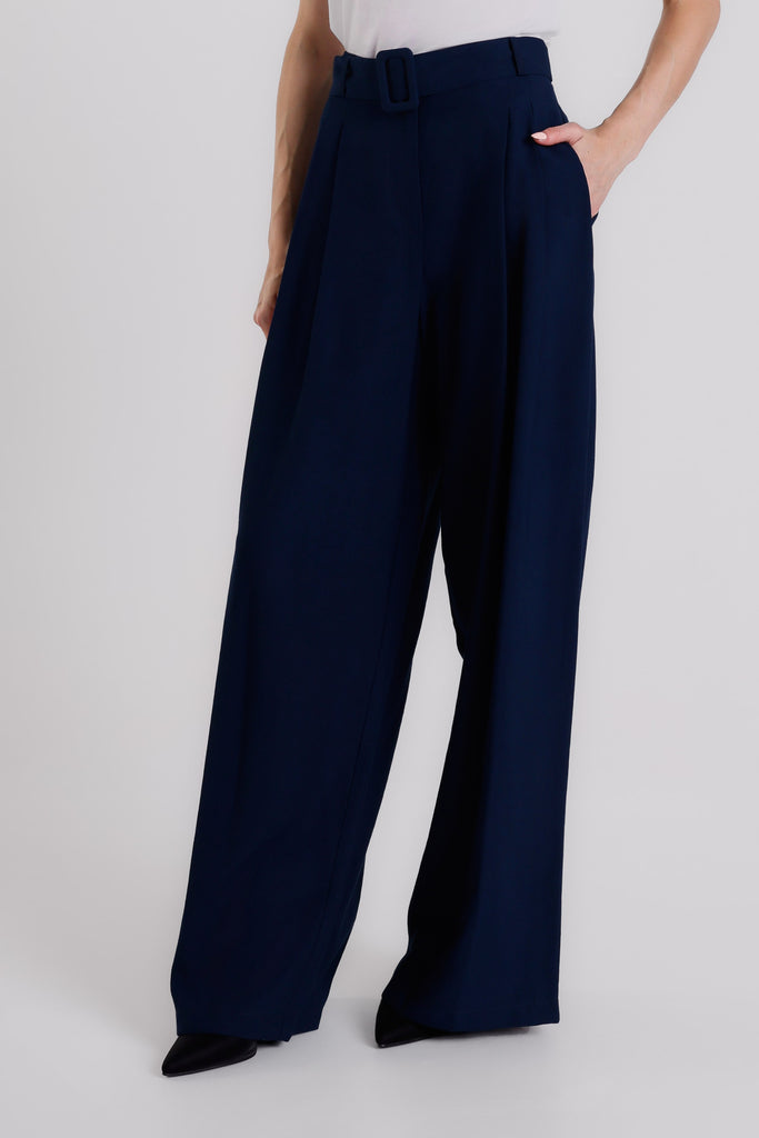 Navy blue wide-leg pants worn by a person on a white background